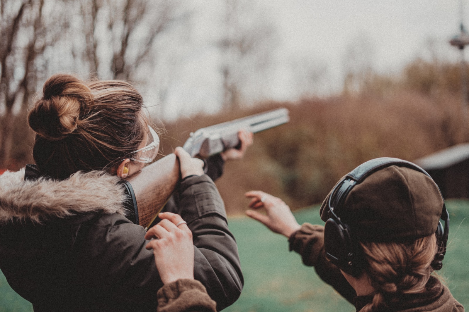 Browning A5 two women are aiming a gun at a target