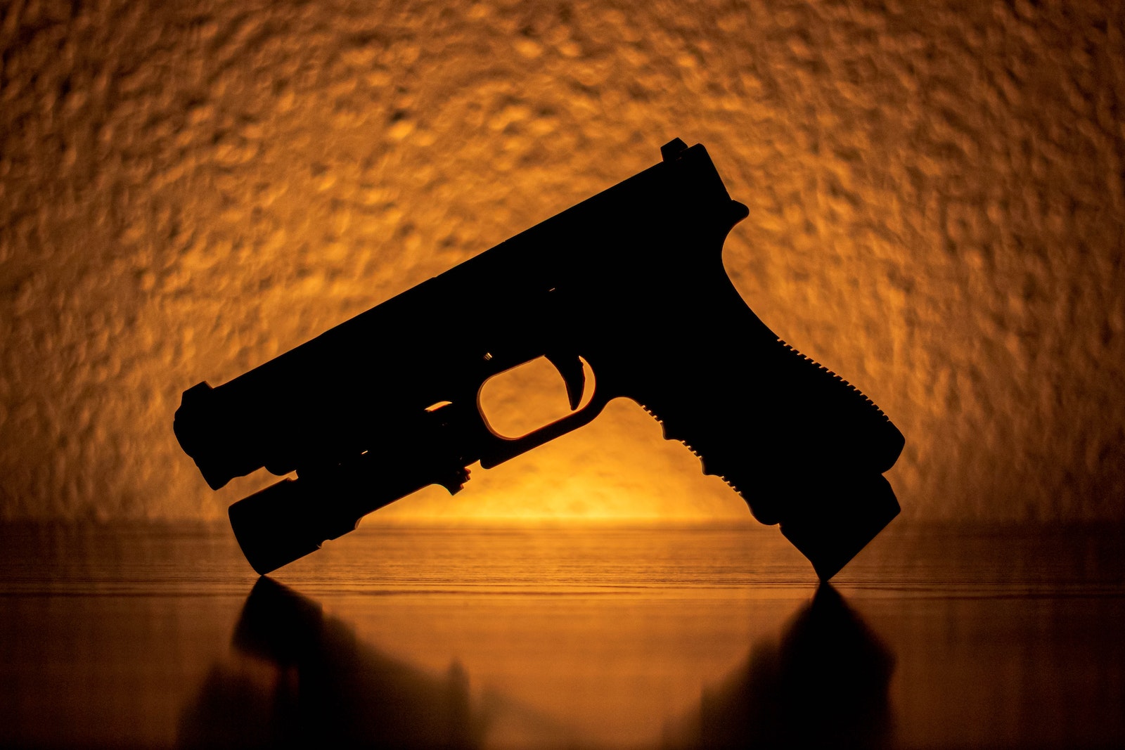 Glock 19 Gen 4 Silhouette of a Pistol Near an Orange Light