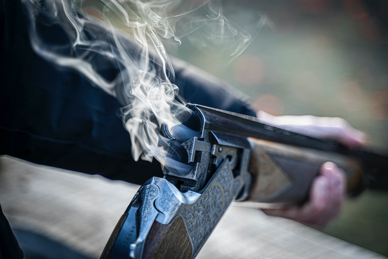 James Purdey & Sons black semi automatic pistol with white smoke