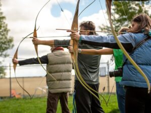 three person practicing using arrow - Archery 101