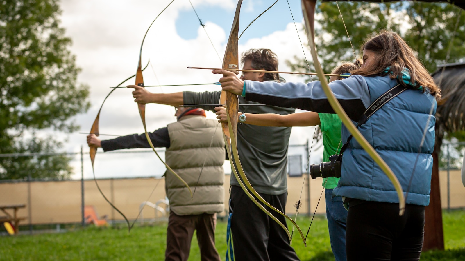 three person practicing using arrow - Archery 101